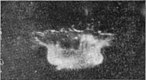 3 0·002 sec. — The crater walls have begun to rise above the surface, with a ruffled rim throwing out short arms to either side.