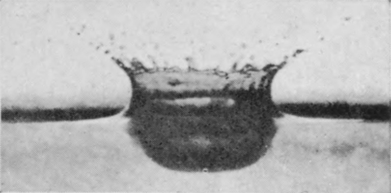 3 0·009 sec. — Above the surface the crater walls rise and fling out spray; below it the cavity is already a deep, rounded hollow.