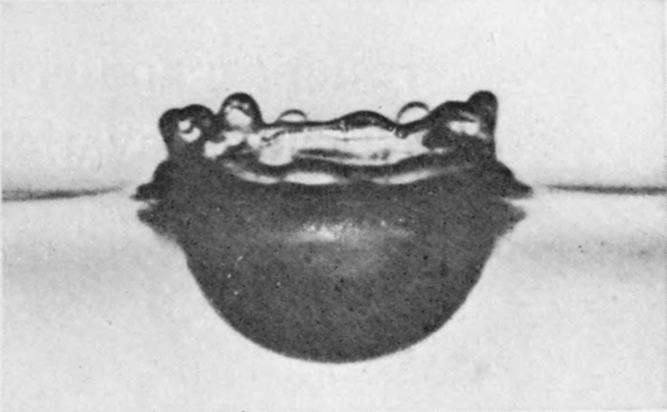 7 0·039 sec. — The cavity has widened further and its floor is flattening; the crater above is sinking, its rim a low wavy ring of rounded beads.