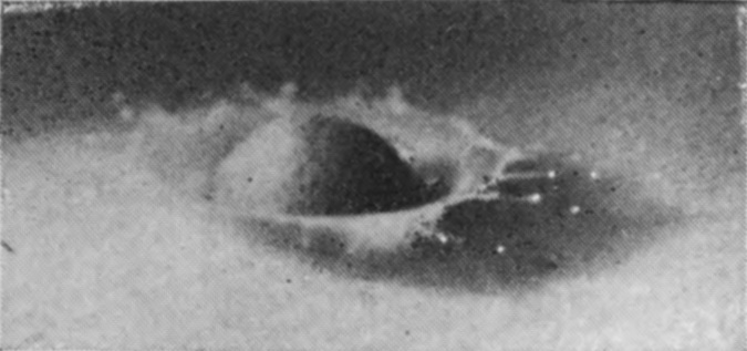 3 0·006 sec. — The sphere is half sunk with its upper part still dry, and a ragged, irregular crater wall is beginning to rise around it.