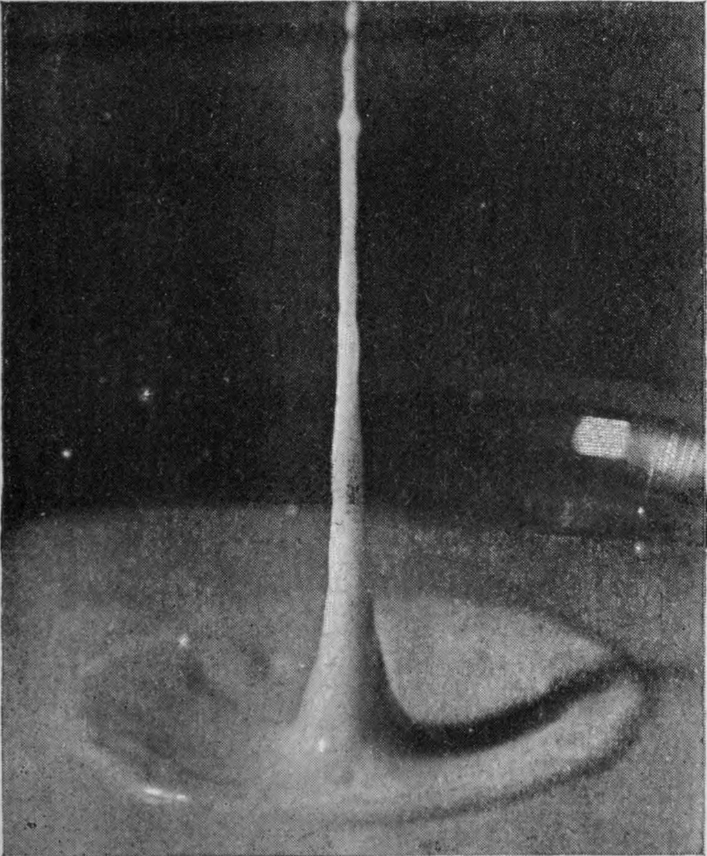 13 0·088 sec. — The jet has gathered volume from below into a tall, tapering column standing out of a shallow basin in the surface.