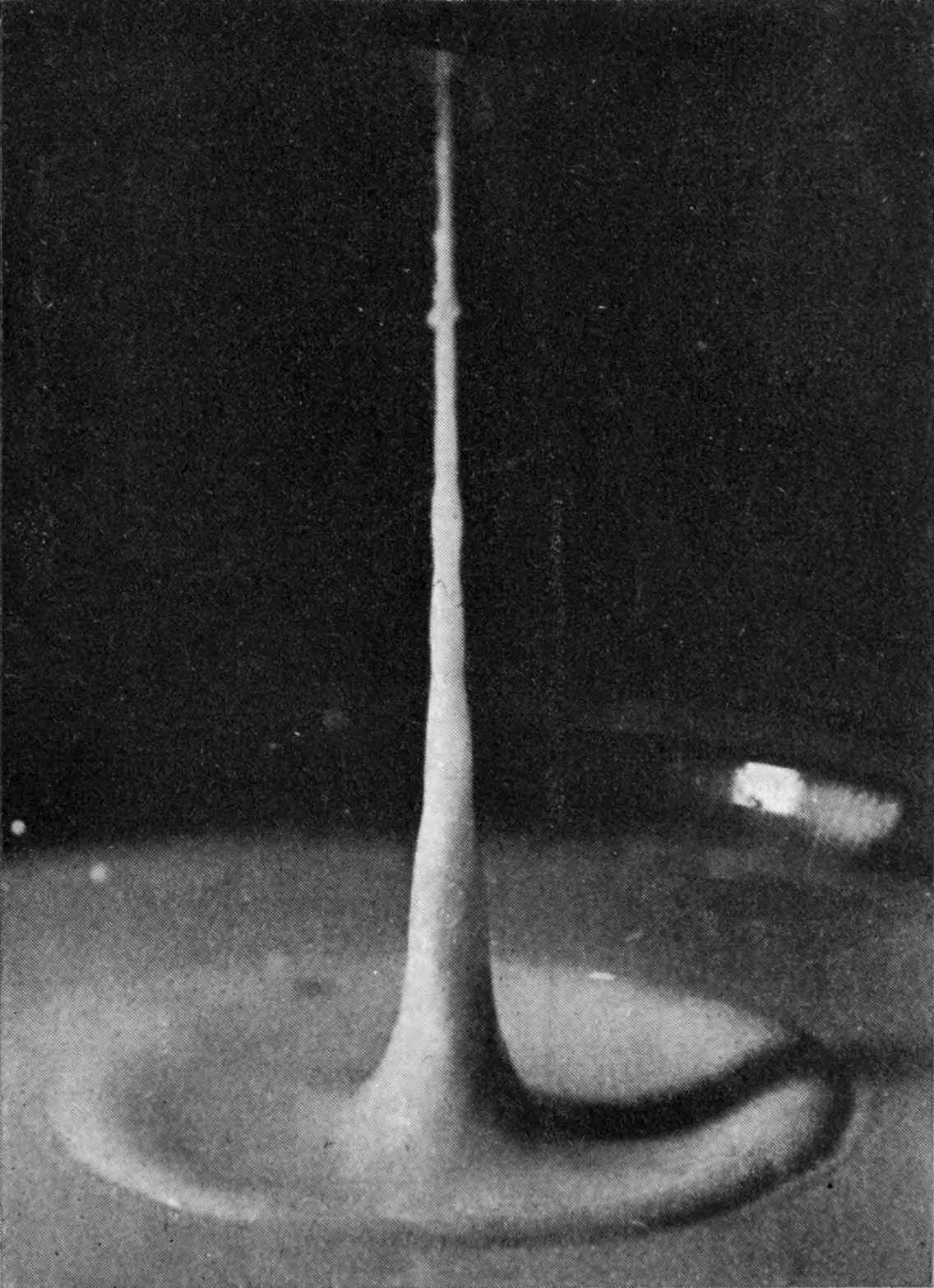 14 0·100 sec. — The column stands tall and graceful, thick at its base and narrowing upward, above the last low ring of the crater.