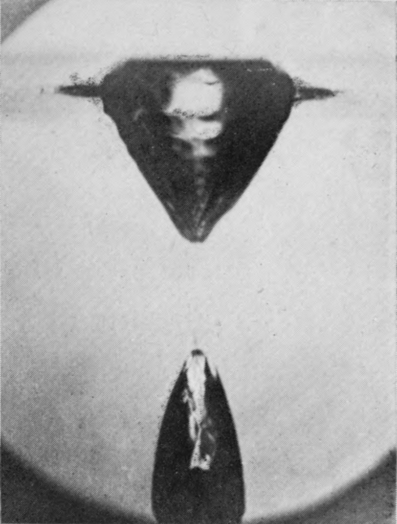 7 — The hollow has divided: a V-shaped basin hangs from the surface above, and far below is the pointed top of the bubble following the sphere.