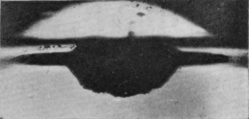 11 — The basin at the surface has almost filled in from all sides, leaving a flattened hollow with the tip of the jet just showing above its centre.