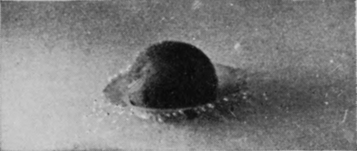 1 T = 0 — The rough sphere at first contact, the liquid already driven back from its surface into a thin beaded ring around its base.