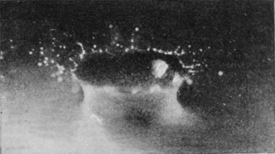 2 0·003 sec. — A thin crater wall is flung up and outward around the sphere, breaking at its rim into a ring of scattered drops.