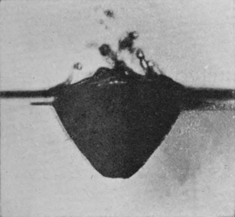 2 0·060 sec. — The funnel below the surface is shallower, and above the surface line torn fragments of the burst bubble are thrown upward as drops.
