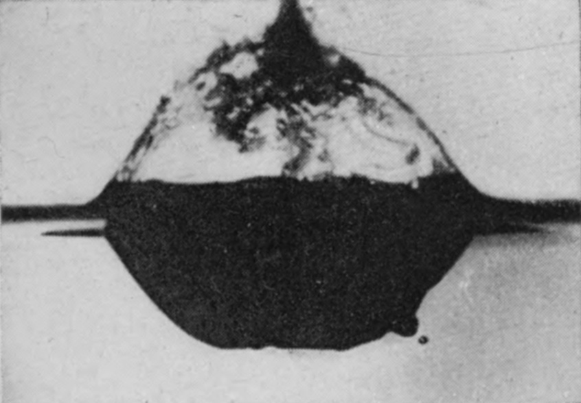 4 0·070 sec. — A closed bubble stands above the surface over its cavity, its thin wall streaked and puckered where the rising jet is pushing through the summit.