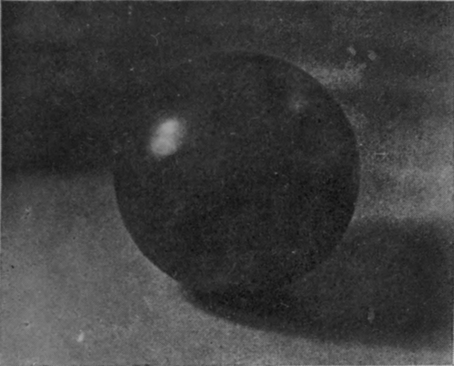 1 T = 0 — The polished sphere, a bright highlight on its side, at the moment of contact with the surface, its shadow lying behind it.