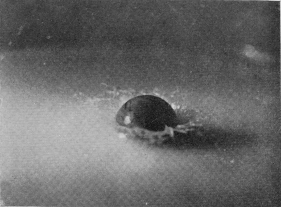1 T = 0 — The wet sphere enters and a ragged ring of liquid rises unevenly at its base, with small jets beginning on one side.