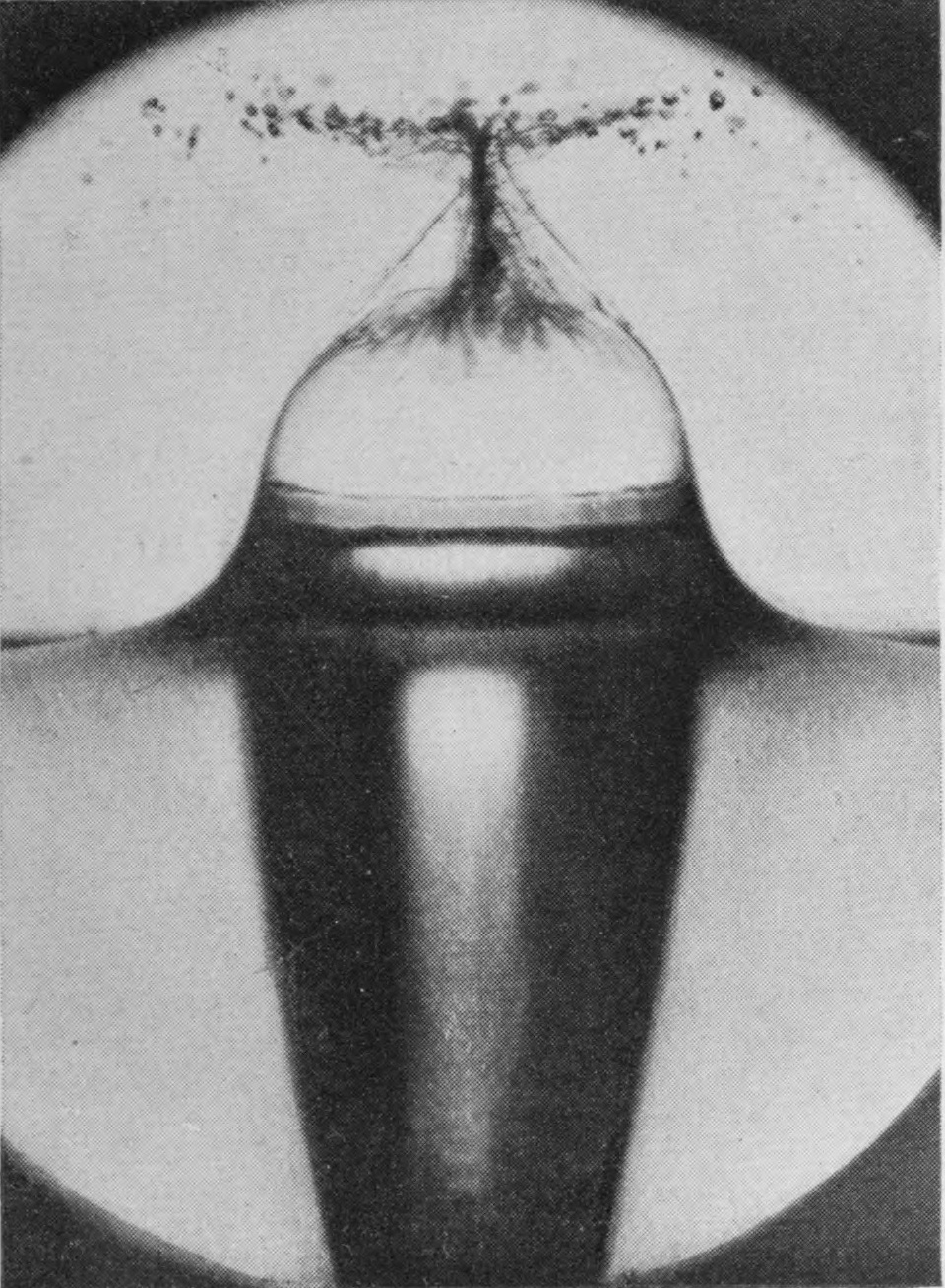 3 0·015 sec. — The crater has closed over at the top into a bubble, its walls drawn together into a twisted spout of spray, above a long air-tube tapering downward.