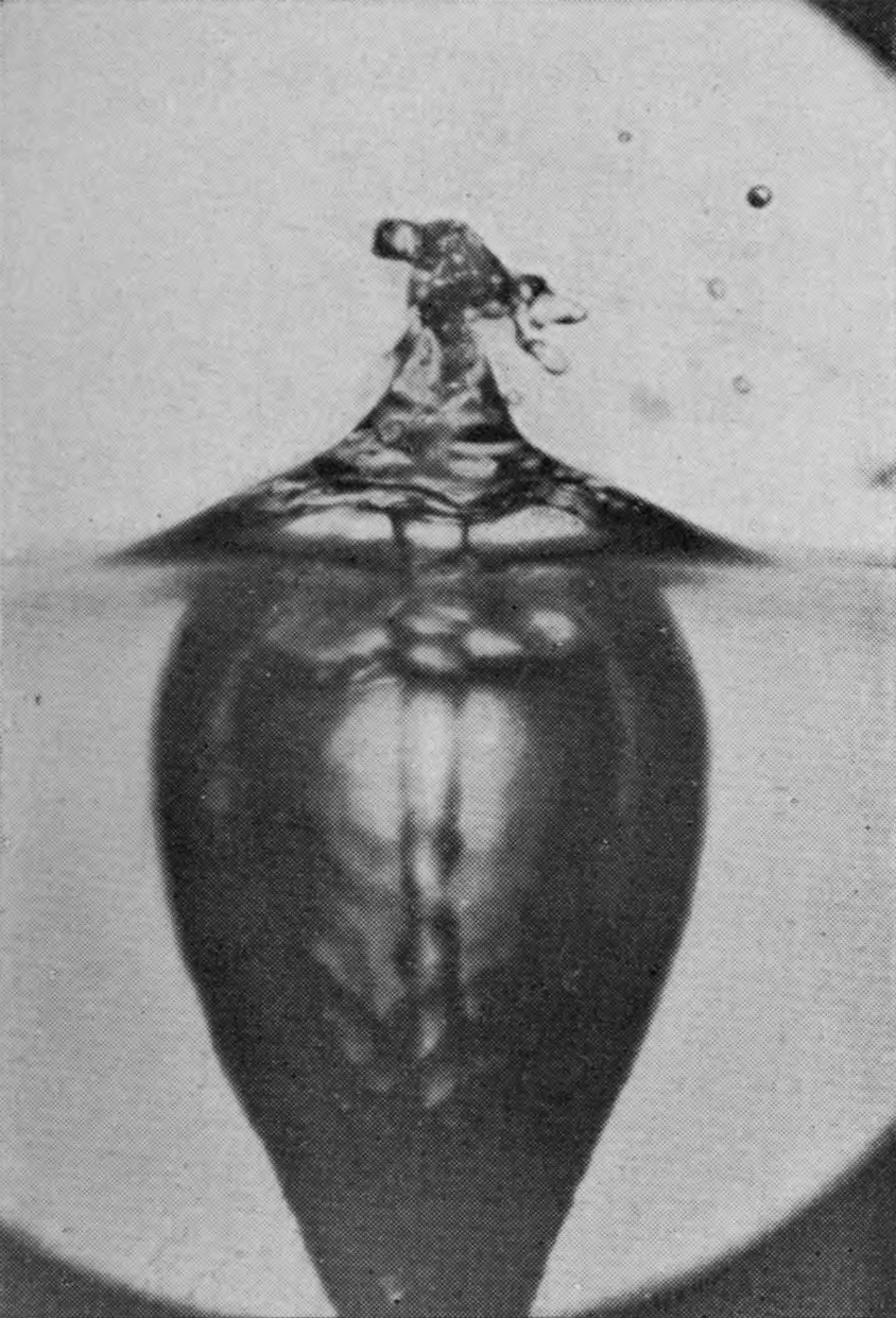 8 0·057 sec. — A conical heap stands above the surface; below it the pear-shaped chamber, with the jet visible down its core, tapers away into the narrowing air-tube.