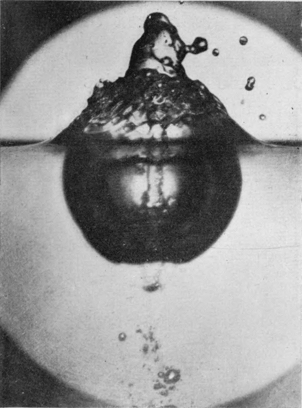 10 0·073 sec. — The heap above the surface is larger and flings off drops; the air-chamber below has become rounder, with small bubbles strung out underneath.
