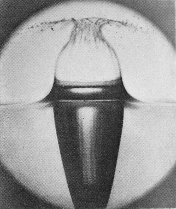 3 0·005 sec. — The crater walls lean together towards closing and the air-cavity below reaches deeper, with faint streaks down its sides.